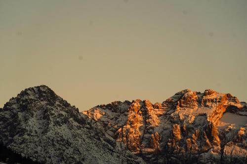 a view of a mountain with snow on it at Lärchenwirt Dolomites in San Nicolò di Comelico