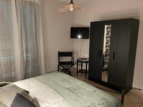 a bedroom with a bed and a mirror and a chair at The Loft E&E Cinecittà in Empoli