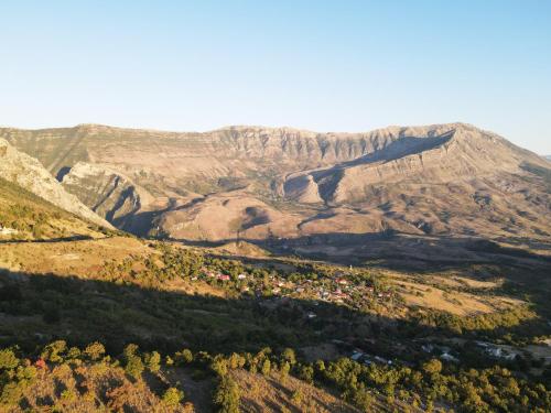 an aerial view of a mountain with a town at Hani Ilos in Stegopul