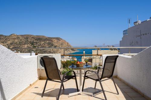 a patio with a table and chairs on a balcony at Adonis Hotel in Agia Galini