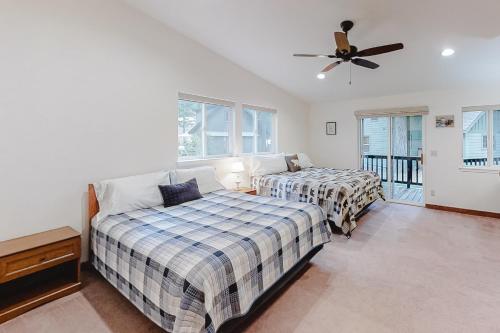 a bedroom with two beds and a ceiling fan at Glacier Lake in Joseph