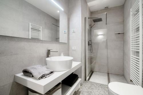 a white bathroom with a sink and a toilet at Ortensie & Oleandri al Lago - by MyHomeInComo in Argegno