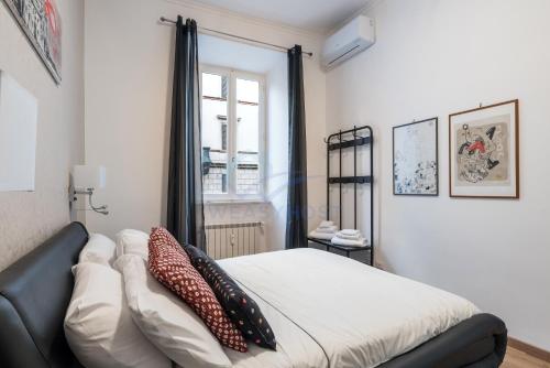 a bedroom with a bed with pillows on it at NEW! Completely renovated apt in Vatican! in Rome