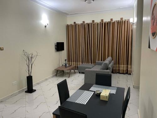 a living room with a couch and a table at Jaffa Suites in Kampala
