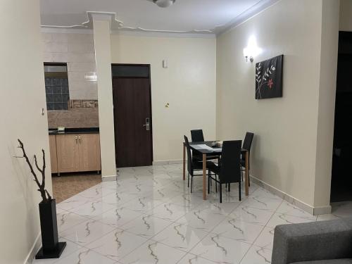 a dining room with a table and chairs at Jaffa Suites in Kampala