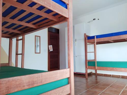 a room with two bunk beds and a doorway at Slow Hostel - Hospedagem Criativa in João Pessoa