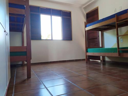 a room with two bunk beds and a window at Slow Hostel - Hospedagem Criativa in João Pessoa