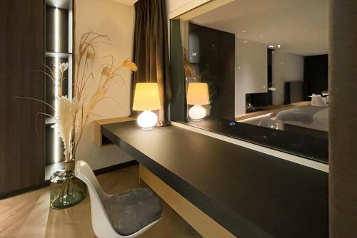 a hotel room with a desk and a mirror at Le19 Suite Georges & Lucy in Namur
