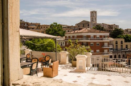 a balcony with chairs and a view of a city at Hotel Iris in Perugia