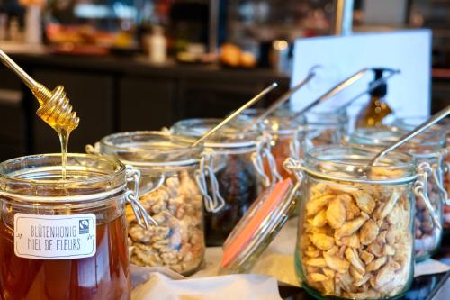 a group of jars of nuts and honey on a table at Hôtel Oasis in Moutier