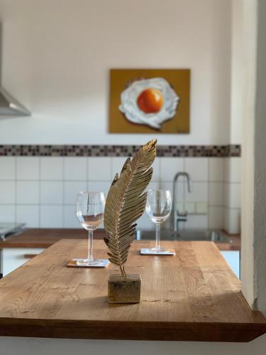 a wooden table with two wine glasses on it at trash de luxe in Schleswig