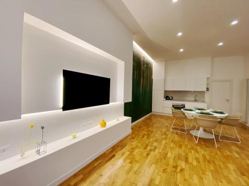 a living room with a television and a dining room table at STAY home experience in Perugia