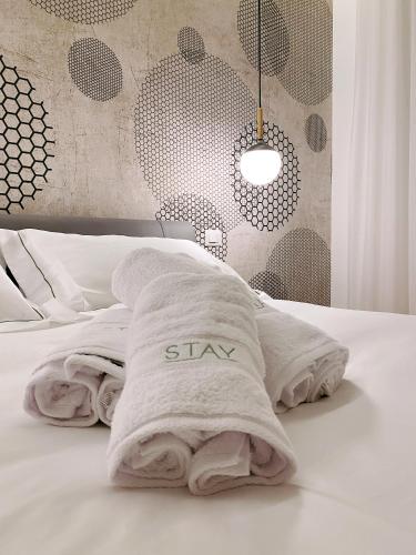 a white bed with a stay pillow on it at STAY home experience in Perugia