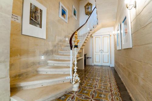a staircase in a home with wooden walls at Monreal Boutique Townhouse - R024RM5 in Paola