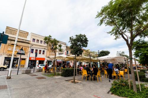 a group of people sitting at tables under umbrellas at Monreal Boutique Townhouse - R024RM5 in Paola
