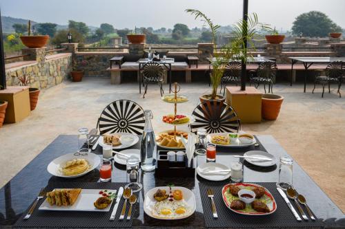 a table with plates of food on a patio at Little Affair in Tehla