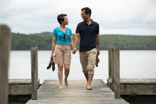 a man and a woman walking on a dock at Silver Birches Resort in Hawley