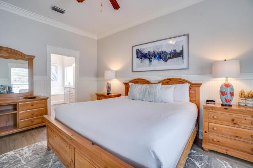 a bedroom with a large white bed and wooden furniture at 30A Beach House - Walking on Sunshine in Inlet Beach