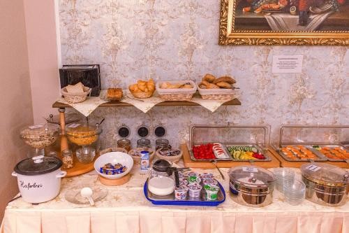 a table topped with lots of food on top at Hotel Römerhof in Baden-Baden