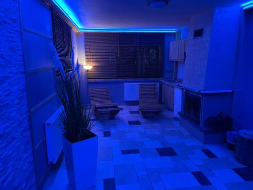 a dark room with a blue light in a kitchen at Willa Brzozówka in Milówka