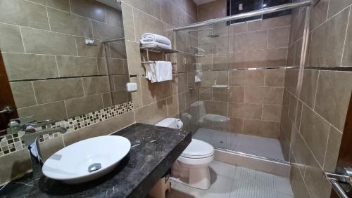 a bathroom with a sink and a toilet and a shower at Hotel Imperio Real in Trujillo