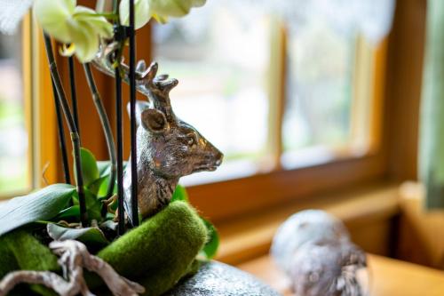 a figurine of a deer next to a plant at Biobauernhof Tonimörtl in Mariapfarr