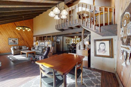 a dining room with a table and a staircase at Meadowlark in Joseph
