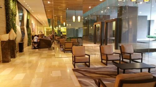 a lobby with chairs and tables in a building at MCity Jalan Ampang KLCC in Kuala Lumpur