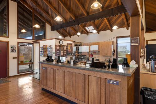 a kitchen with a bar in a restaurant at Harbor Lite Lodge in Fort Bragg