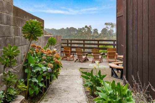 a patio with chairs and flowers on a fence at Harbor Lite Lodge in Fort Bragg