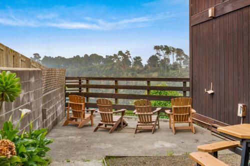 a group of chairs and tables on a patio at Harbor Lite Lodge in Fort Bragg