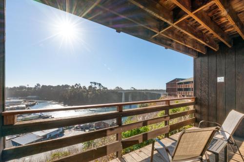 a balcony with two chairs and a view of the water at Harbor Lite Lodge in Fort Bragg