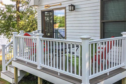 a porch with a white railing and a door at Loons Nest Cottage in Standish