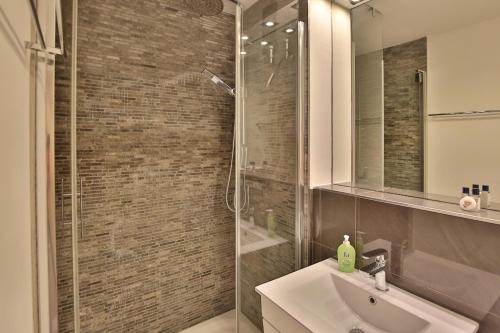 a bathroom with a sink and a glass shower at Residenz Ostseestrand Appartement 26 in Scharbeutz