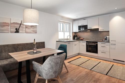 a kitchen with a table and chairs in a room at Wieslbauer in Flachau