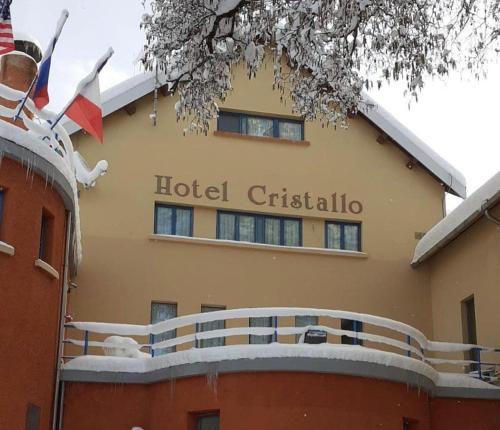 a hotel sign on the side of a building at Hotel Cristallo Gran Sasso in LʼAquila