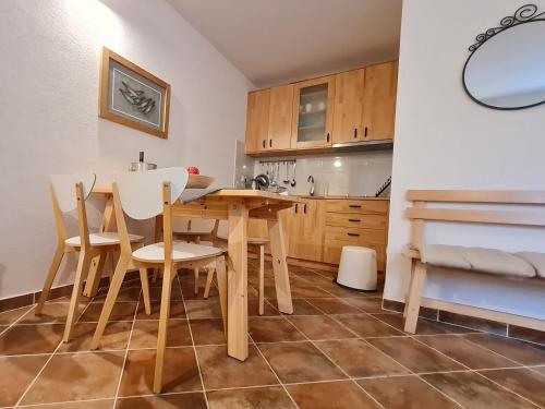 a kitchen with a wooden table and chairs at Sweet House and Apartment in Rovinj