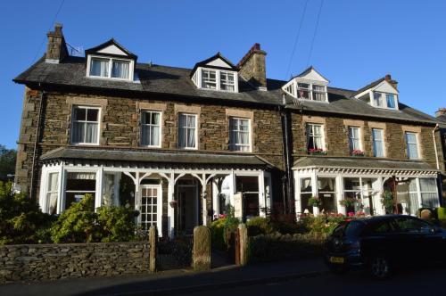 a house with a car parked in front of it at Ellerbrook House in Windermere