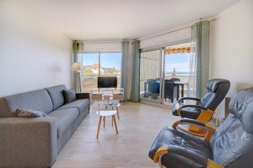 un salon avec un canapé, des fauteuils et une télévision dans l'établissement IMMOGROOM -Panoramic sea view terrace-2min from the beach, à Cannes
