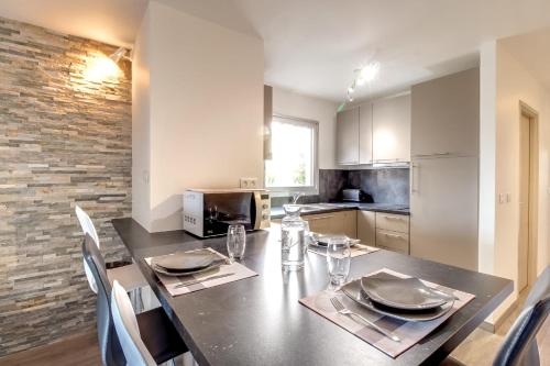 une cuisine avec une table avec des assiettes et des verres dessus dans l'établissement IMMOGROOM- Renovated - Wifi - Close to everything, à Cannes