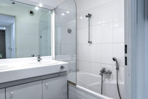 une salle de bain blanche avec un lavabo et une douche dans l'établissement IMMOGROOM - 3min from beach - AC - 10min from Palais - Wifi, à Cannes