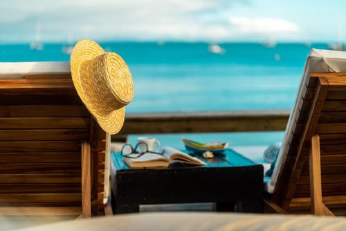 a straw hat sitting on a table near the beach at Pousada dos Sonhos in Florianópolis