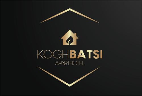 a gold logo with a arrow in a hexagon at Koghbatsi Aparthotel in Yerevan