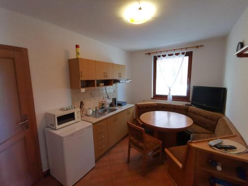 a small kitchen with a table and a microwave at Apartmány Rajecká Dolina in Rajecké Teplice