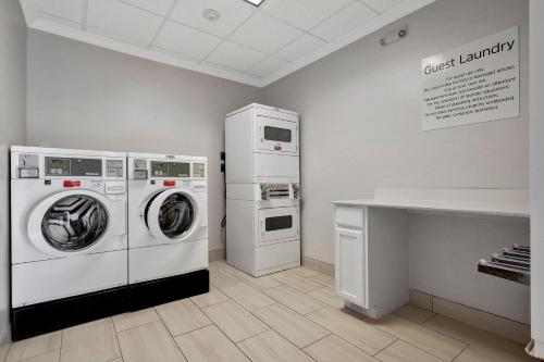 a laundry room with two machines and a counter at Holiday Inn Express Hotel & Suites Lufkin South by IHG in Lufkin