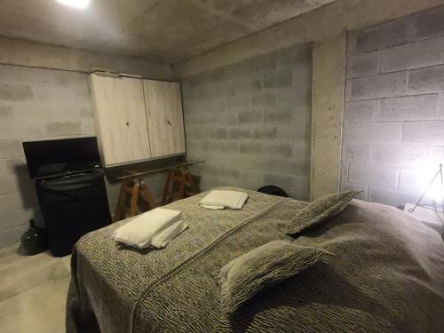 un dormitorio con cama con dos toallas en Trastolillo Villa Gesell en Villa Gesell