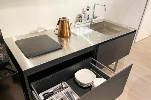 a kitchen counter with a sink and a sink at RESIDENCE HARIMAYA-Vacation STAY 99860v in Kochi