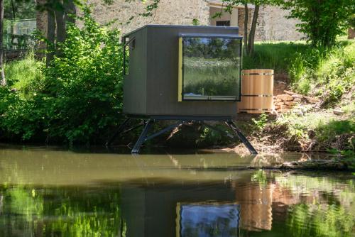 a tv sitting in the middle of a body of water at Samota Hojšín in Neustupov