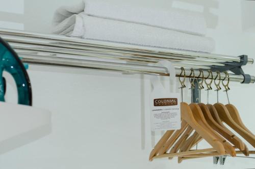 a rack with wooden utensils and towels at Hotel Colonial Mexicali in Mexicali