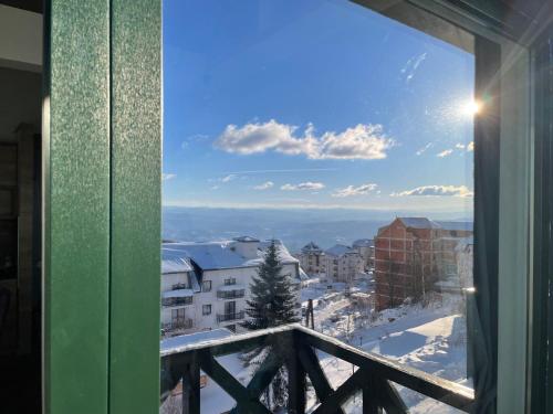 a view from a window of a snowy city at Pano Kopaonik Panorama in Kopaonik